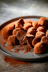 Tasty chocolate truffles powdered with cocoa on table.
Chocolate truffles image.
