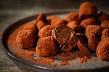 Tasty chocolate truffles powdered with cocoa on table.
Chocolate truffles image.
