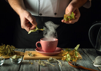 Hands expertly prepare a hot cup of herbal tea, surrounded by fresh ingredients and steam rising from the delicate pink cup. The warm ambiance evokes a sense of comfort and tranquility