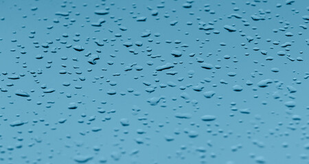 Sky blue background with raindrops pattern on glass. Banner with raindrop texture on window