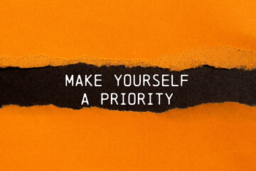 Make yourself a priority message written on ripped torn orange paper with black background....