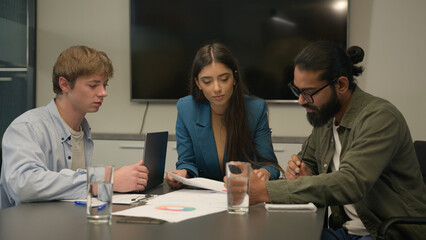 Business partners colleagues female woman leader male men employees at office boardroom talking discuss project plan analyzing corporate documents multiracial businesswoman businessmen collaboration