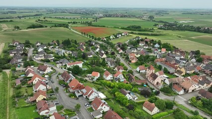 Aerial view of a picturesque rural village with scenic farmland and tranquil greenery, Kochersberg, France. - Powered by Adobe