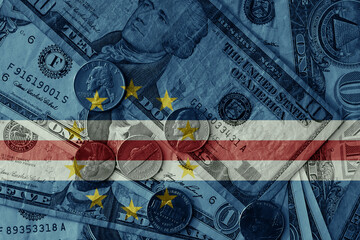 Fototapeta premium colourful flag of cape verde on a dollar money banknotes and coins background. finance concept. macro shot