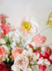 Bright and colorful bouquet featuring various spring flowers in a soft background