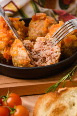 Cutting Open Juicy Meatball with Rice and Tomato Sauce