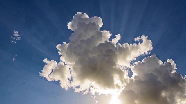 A stunning 4K cinemagraph time-lapse capturing fluffy, puffy white cirrus and cirrostratus clouds drifting gracefully across a vibrant, clear blue sky. 