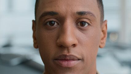 Close-up in details serious worried african american man raise head looking at camera sad face tired gaze dark eyes pensive frustrated upset ethnic male 30s guy businessman client ophthalmology clinic