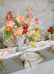 Elegant dining table adorned with a vibrant floral centerpiece and fine tableware for a special occasion