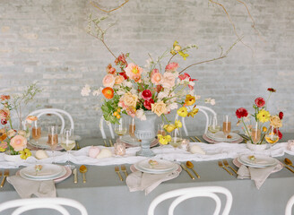 Elegant floral arrangement on a beautifully set dining table for a spring celebration in a stylish venue