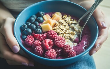 Delicious Berry Smoothie Bowl with Raspberries, Blueberries, Peach, and Oats