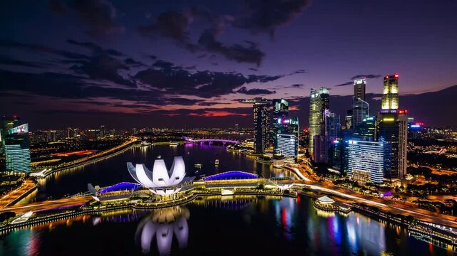 A stunning 4K aerial hyperlapse capturing the iconic Marina Bay Sands in the heart of Singapore's vibrant city skyline. 
