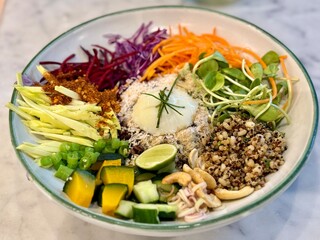 Khao Yam is a food from the northern part of Thailand. Healthy food background with a delicious rice salad with colorful chopped vegetables , Close up and selective focus.