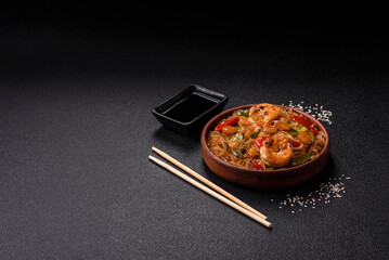 Glass noodles with shrimps and seafood, vegetables, spices and soy sauce