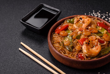 Glass noodles with shrimps and seafood, vegetables, spices and soy sauce