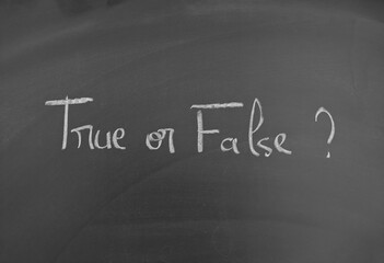 Fototapeta premium True or False written with chalk on a dark blackboard for learning or evaluation