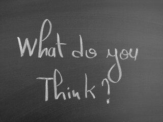 Obraz premium Handwritten message on a chalkboard asking 'What do you think?' with elegant script.