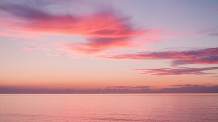 Obraz premium A serene sunrise over calm waters, painted with soft pink and purple hues, creating a tranquil atmosphere that invites reflection.