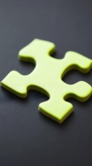 Obraz premium Lime Green Jigsaw Puzzle Piece on Black Background Close Up