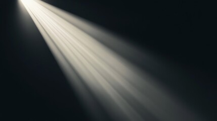Bright light beam shining from top left corner on dark background.