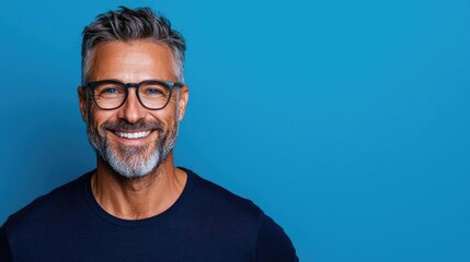 Obraz premium Smiling mature man, blue background, portrait, website banner