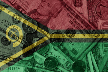 colourful flag of Vanuatu on a dollar money banknotes and coins background. finance concept. macro...
