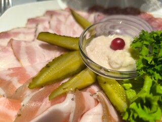Delicious sliced meat on a plate with herbs