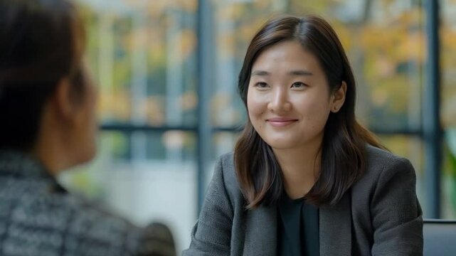Confident Asian Woman Smiling During Job Interview, Professional Workplace Interaction, Positive Employment Conversation, Businesswoman at Work