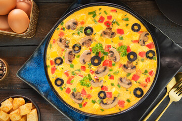 Delicious Mediterranean veggie omelette. Top view with close up.