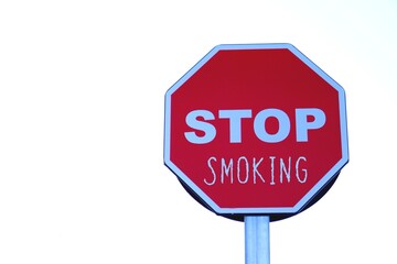 Stop smoking. public health problem. letters written on a highway stop sign.