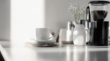 A white coffee mug sits on a table next to a coffee grinder