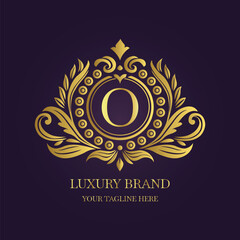Gold Letter 'O' Logo with Ornamental Patterns and Floral Motifs on Purple  
