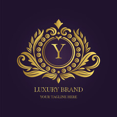 Gold Letter 'Y' Logo with Ornamental Patterns and Floral Motifs on Purple  
