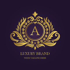 Gold Letter 'A' Logo with Ornamental Patterns and Floral Motifs on Purple  
