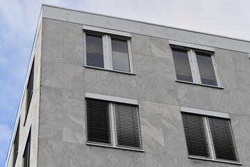 Photo of the front of a minimalist office building in a city