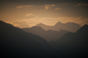 Golden sunset over the rugged peaks of the karakorum range in pakistan, creating a breathtaking view