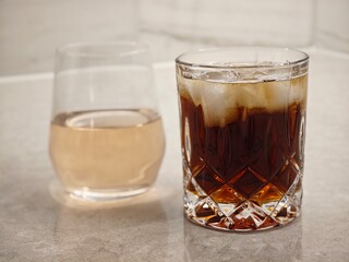 Refreshing drinks on a marble countertop brightened by soft afternoon light