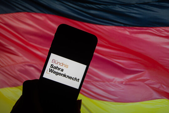 Rheinbach, Germany  26 January 2025,  The logo of the party "B&uuml;ndnis Sahra Wagenknecht" on the display of a smartphone in front of a German flag (focus on the logo)