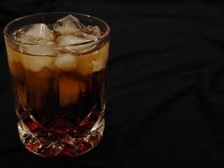Delightful cold beverage served on a stylish table, highlighting elegance and refreshment during a cozy gathering at night