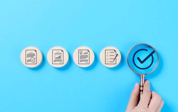 Quality control and certification assurance concept. A magnifying glass highlighting a checkmark certification and quality assurance icons, standard compliance, approval, and business quality control.