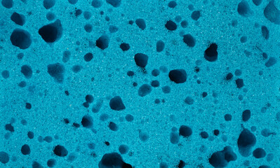 Close up view of textured scrub sponge in vibrant blue