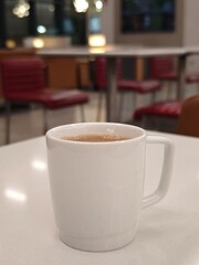 Fototapeta premium Cozy coffee moment captured in a quiet cafe setting during a relaxing afternoon with soft lighting