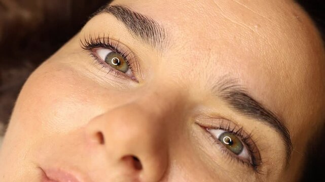 makeup artist doing eyelash lamination for a client
