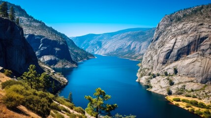 Hetch Hetchy Reservoir on a Beautiful Alpine Day in California's Sierra Nevada Mountains; Wapama and Tueeulala Falls Visible Across the Blue Lake