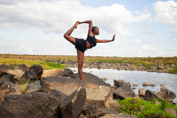 black woman in yoga dancer's pose, also known as Natarajasana