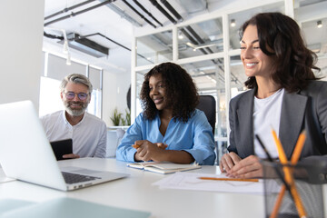 Group of business people working together as teamwork while sitting at office desk
