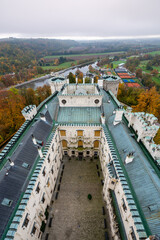 Aerial view of Hluboka Castle in the Czech Republic, highlighting the roof and surrounding area. This stunning landmark is a masterpiece of neo-gothic architecture in South Bohemia
