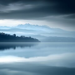 Fototapeta premium Serene Misty Lake with Snow-capped Mountains