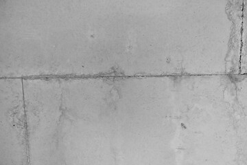 Concrete wall with subtle texture and cracks in a muted color scheme