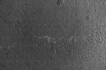 Textured concrete surface with subtle markings and shadows in monochrome